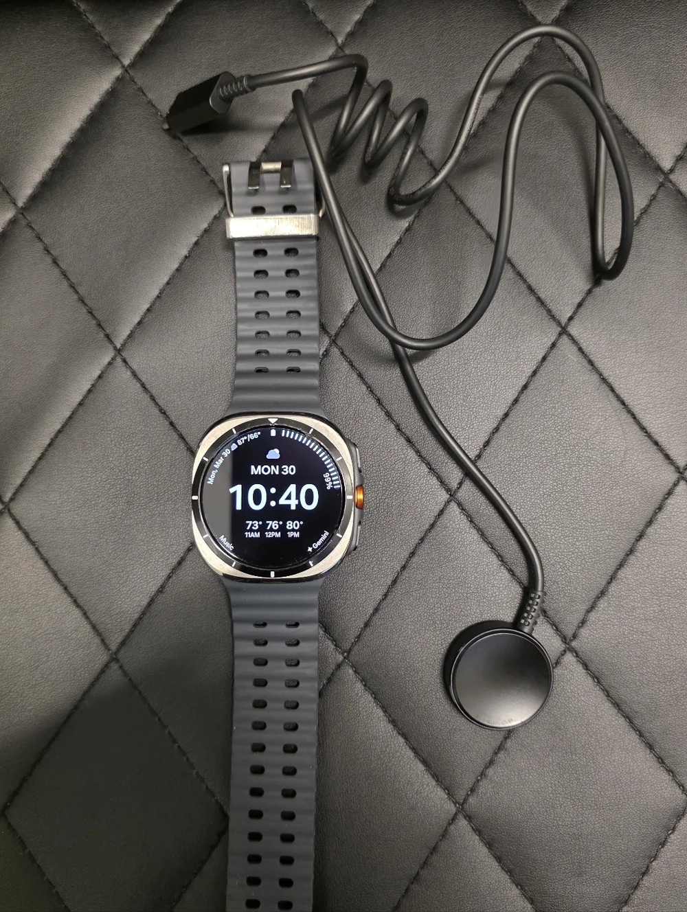 Samsung Gray Smartwatch with Orange Accent and Dark Gray Band